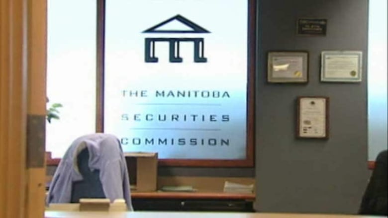 A window has a stylized logo of the letter M on it, with the words: The Manitoba Securities Commission below. In the foreground of the window is an office with a chair and desk.