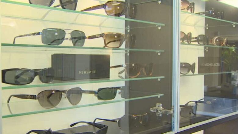 Sunglasses line a display case