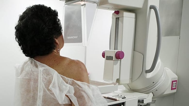 A woman getting a breast mammogram