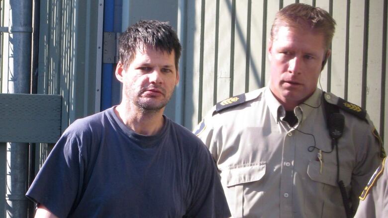 Randall Hopley, left, is led out of the Cranbrook, B.C. courthouse on Sept. 14, 2011. Hopley has been declared a long-term offender and faces a prison term with a period of supervision after his release. THE CANADIAN PRESS/Bill Graveland