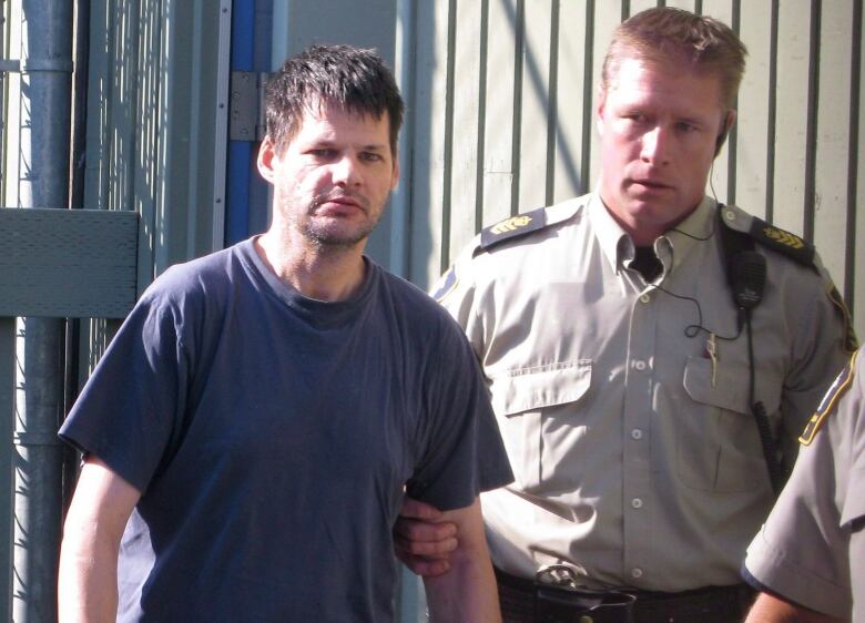 Randall Hopley, left, is led out of the Cranbrook, B.C. courthouse on Sept. 14, 2011. Hopley has been declared a long-term offender and faces a prison term with a period of supervision after his release. THE CANADIAN PRESS/Bill Graveland