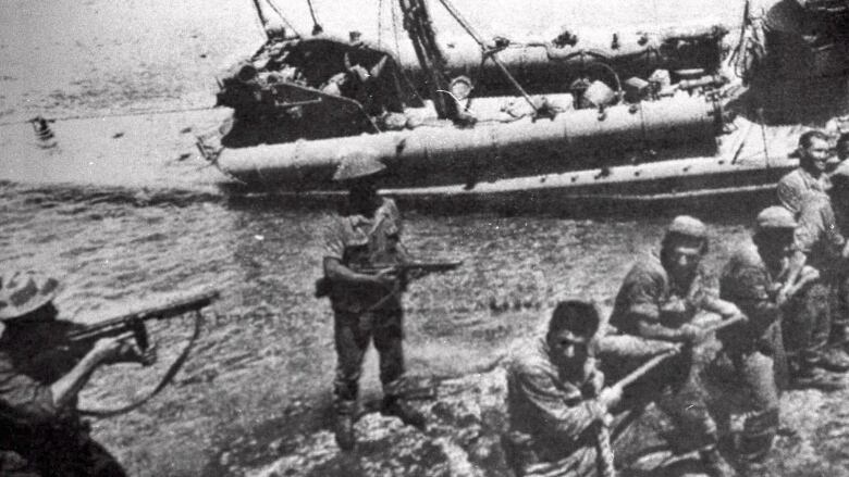 In this file photo dated July 20 1974, Turkish troops pull ashore a Greek Cypriot torpedo boat damaged during fighting in Kyrenia on the day Turkey invaded and occupied the northern third of Cyprus.