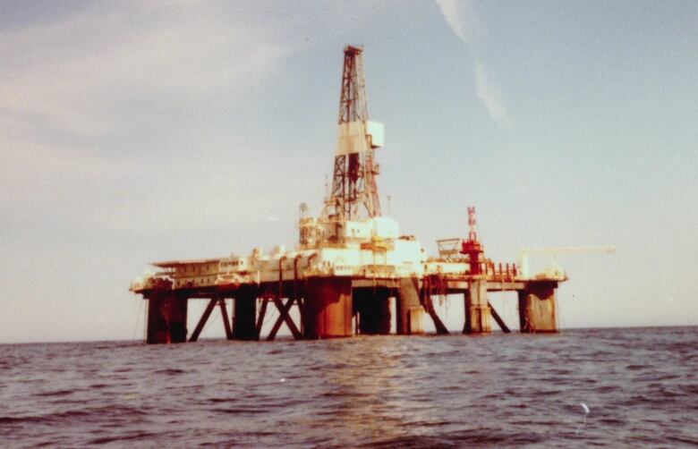 An oil rig sitting in the ocean. 