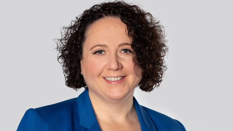 Woman wears a blue blouse. 