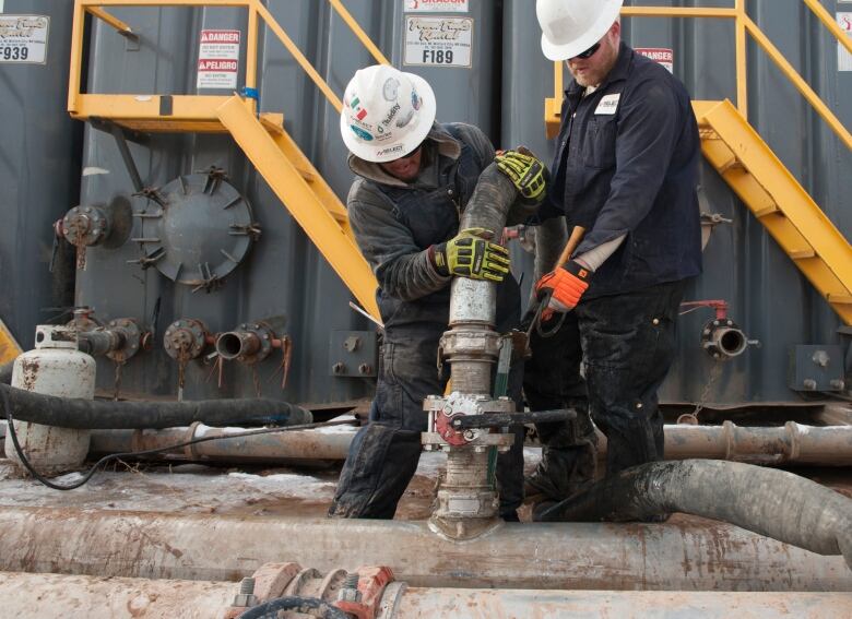 Two oil workers at work.