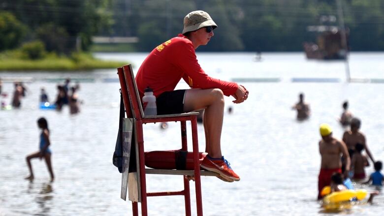 Aa lifeguard keeps an eye on swimmers at a city beach.