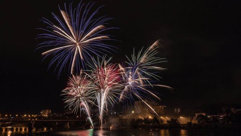 Fireworks can be seen in the sky across the river in Saskatoon