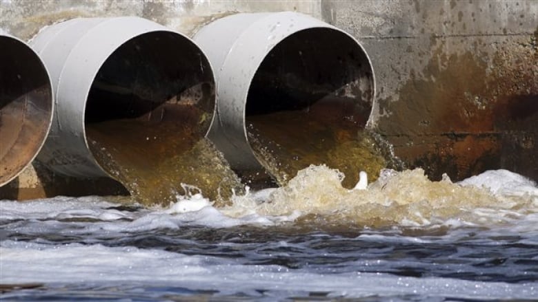 Sewage being dumped into a body of water.