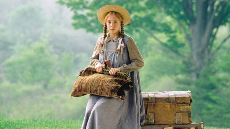 Anne Shirley waits at the train station in a screen shot from the 1985 adaptation of Anne of Green Gables.