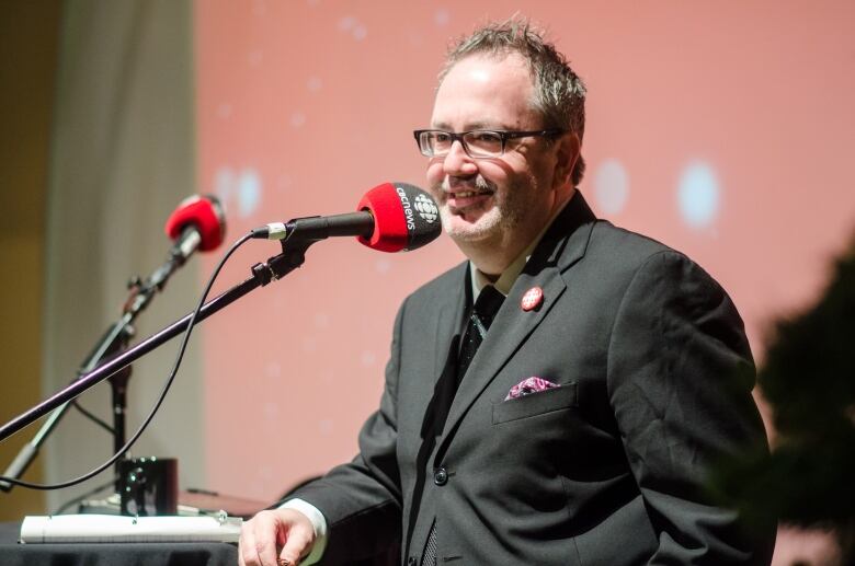 Man stands at microphone