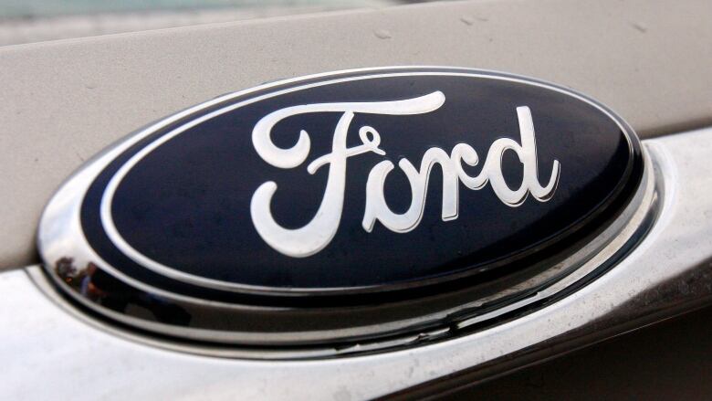 A close up image of the Ford label on the front of a car