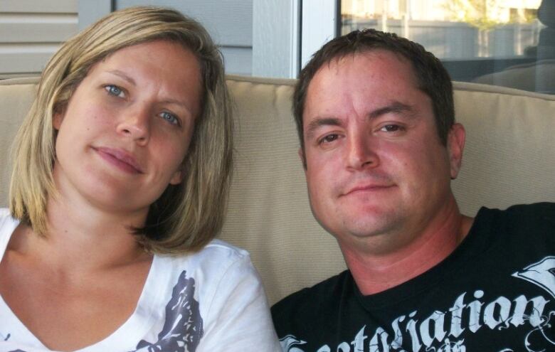 A woman with shoulder-length blond hair sits next to a man with short dark hair.