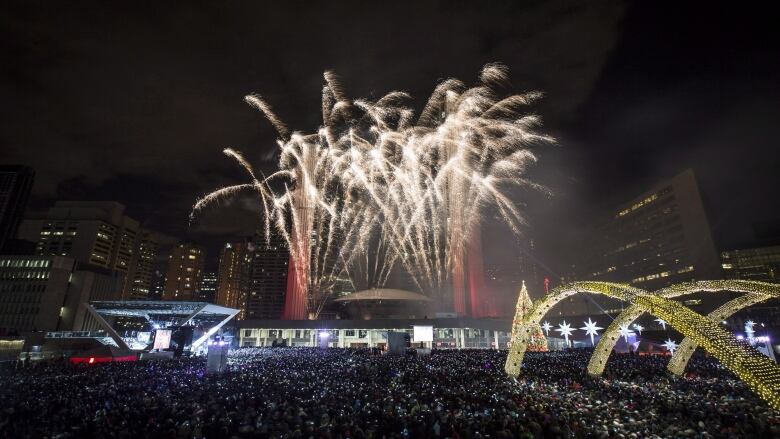 Fireworks go off during New Year's Eve celebrations at Nathan Phillips Square in Toronto 