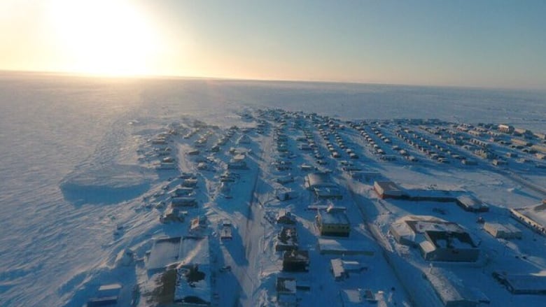 An aerial view of an Arctic hamlet in winter.