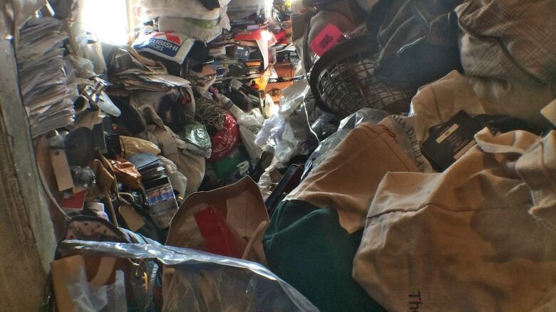 This April 15, 2015 photo provided by Jack Sherratt shows Adam Chrin's fourth-floor apartment in New York, where Chrin lived nearly entombed in filth and squalor, amid hoarded, floor-to-ceiling piles of old newspapers, rumpled clothes, books, shopping bags, food scraps, knickknacks and stacks of old records. After a nearby gas explosion in the East Village last year that killed two people, firefighters discovered Chrin, who was forced to get out of his building for several weeks while inspectors made sure it was structurally sound enough to inhabit.