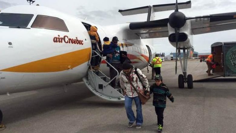 People leaving an airplane.