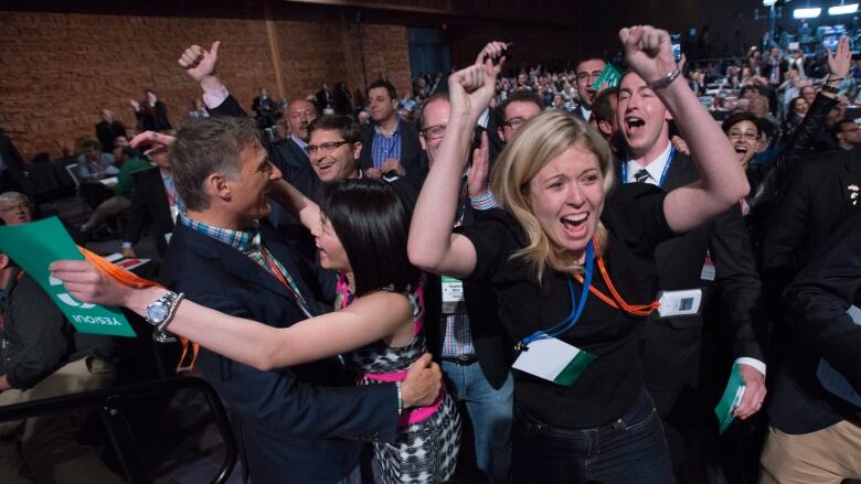 Delegates Michelle Rebel and Natalie Pon celebrate the yes vote to change the wording of the traditional definition of marriage in the conservative policies at the Conservative Party of Canada convention in Vancouver, Saturday, May 28, 2016.