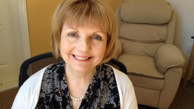 A smiling woman with short brown hair.