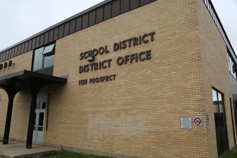 A beige brick building that says 