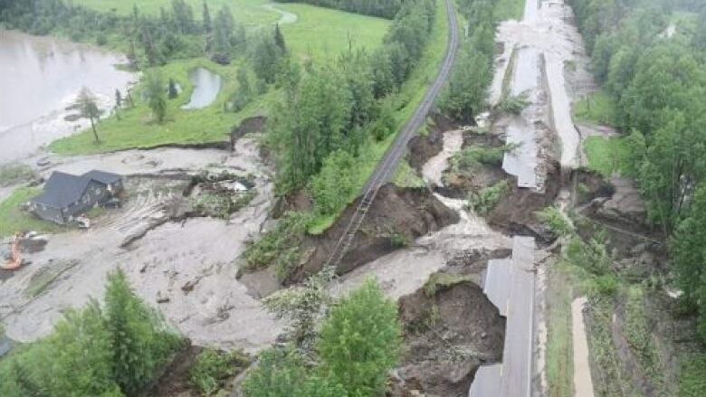 An aerial view of a highway destroyed by flooding.