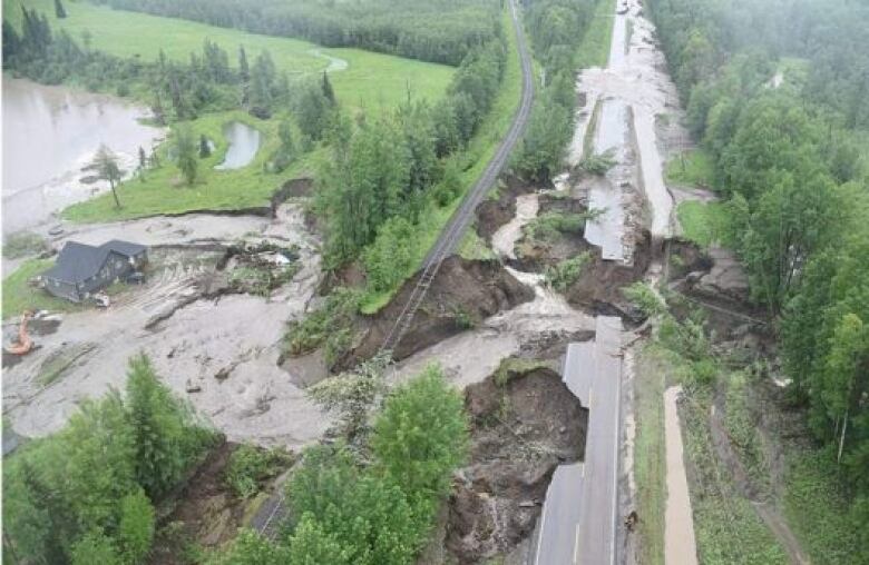 An aerial view of a highway destroyed by flooding.