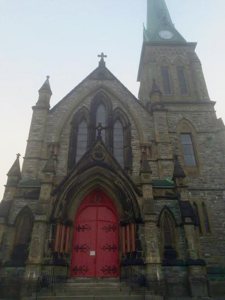 A stone church with a red entryway