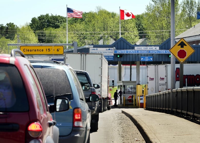 A line of cars heading into a small border crossing station in Calais