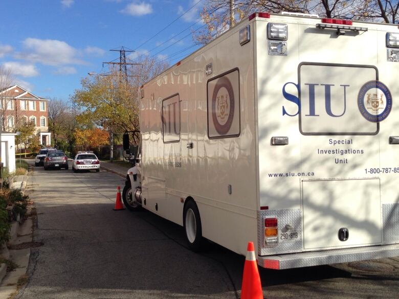 A Special Investigations Unit truck in what looks like a residential neighbourhood.