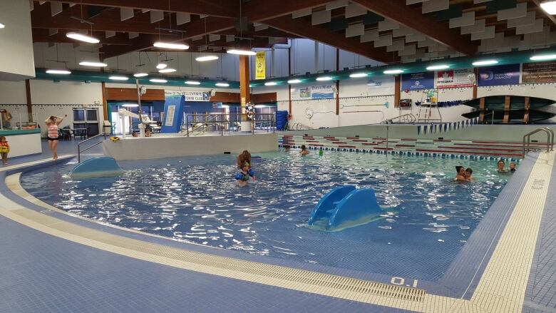 People enjoy an indoor pool full of water.