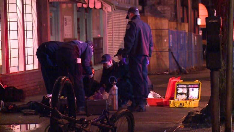 First responders surround an overdose victim on Vancouver's Downtown Eastside.