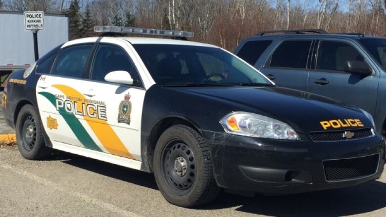 A black-and-white police vehicle is shown parked.