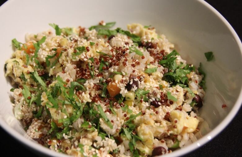 Bowl of quinoa, egg, green onions and sesame seeds