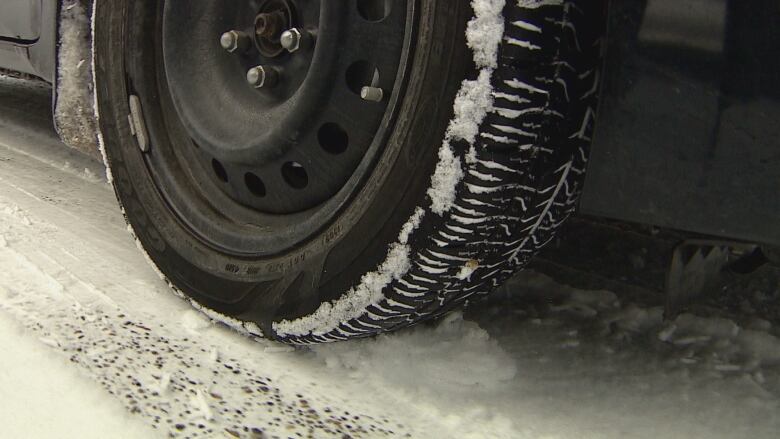 A winter tire on snowy terrain.