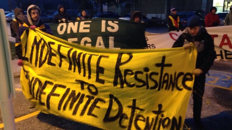 Strangers bundled in parkas and scarves gathered outside the Toronto Immigration Holding Centre on Saturday in a show solidarity for the some 138 detainees inside its walls, according to End Immigration Detention Network numbers.