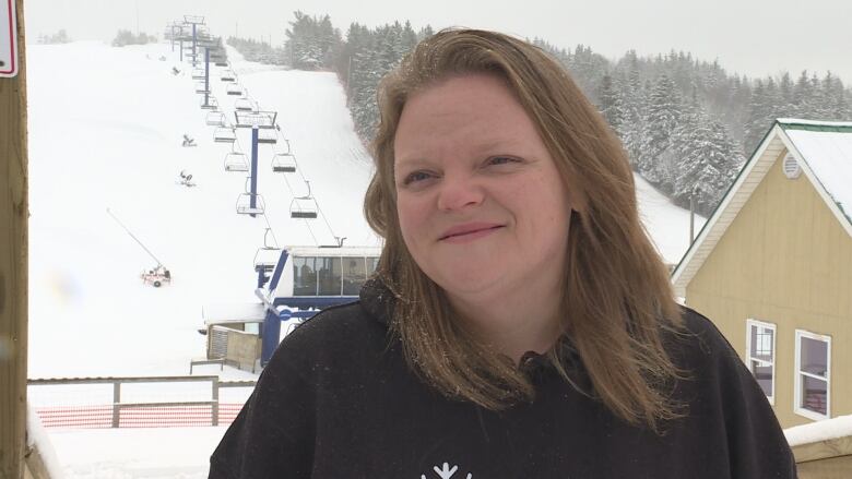 Erin Curley, with the snow-covered hill of Mark Arendz Provincial Ski Park in the background.