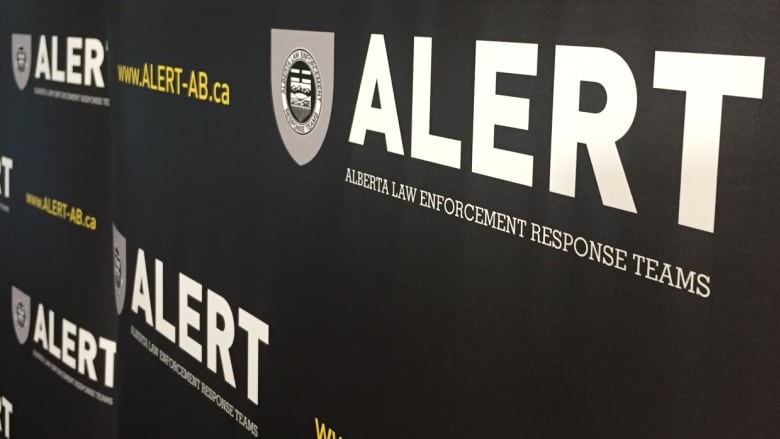 A banner with the Alberta Law Enforcement Response Team's logo on it.