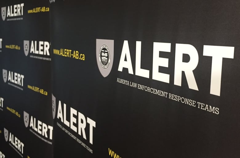 A banner with the Alberta Law Enforcement Response Team's logo on it.