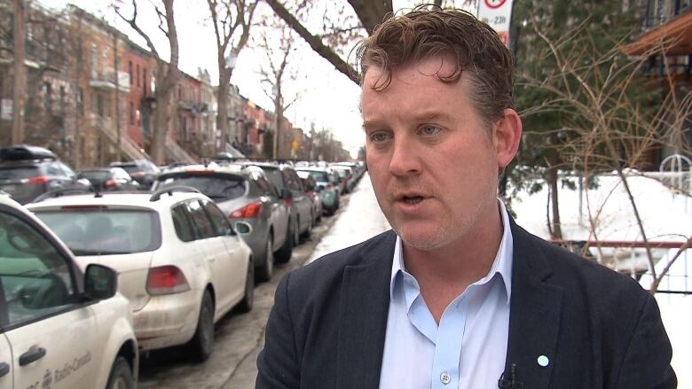 A man in a suit and no coat, though there's snow on the ground. 