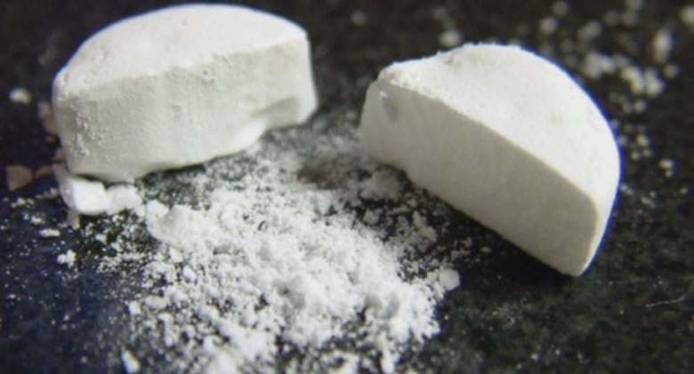 White fentanyl pills are partially crushed.