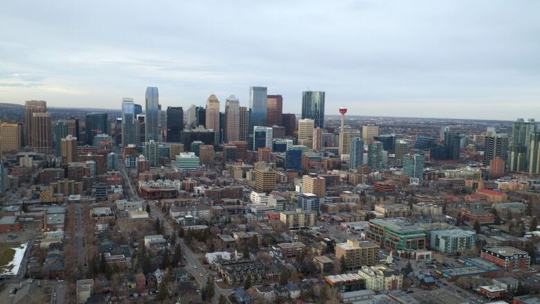 Tall buildings are seen against the sky as smaller buildings dot the forefront of the image. 