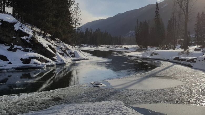 A bend in the Elk River. Mountains are seen in the background.