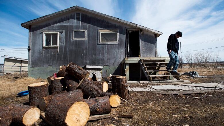 A resident of Attawapiskat, Ont., leaves a house which has been deemed not fit for human habitation. 