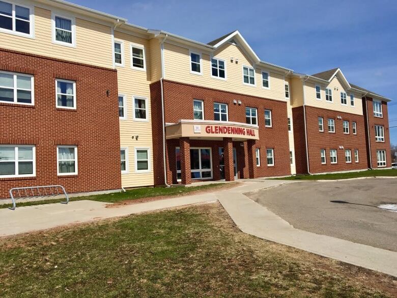 Outside of a student residence, with brick walls. 