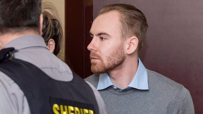 William Sandeson is escorted into his preliminary hearing at provincial court in Halifax