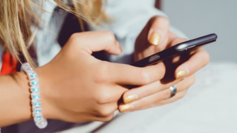 A stock image of a woman using a smartphone.