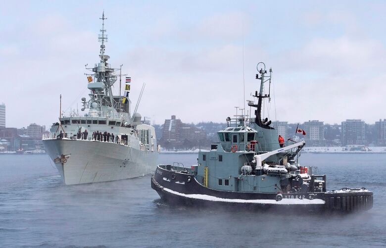 The naval tugboat Glenivis assists as HMCS St. John's heads to the Mediterranean in Halifax on Monday, Jan. 9, 2017. The Halifax-class frigate will be supporting NATO Maritime Group 2 as part of Operation Reassurance.