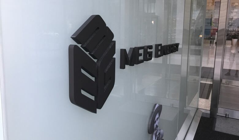 An interior sign in an office building reads MEG Energy.