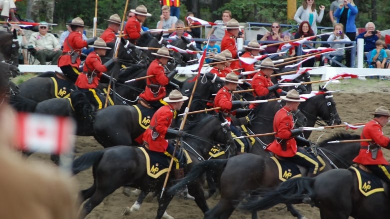 Charge! Officers dip their lances as 32 the black Hanoverian horses rush forward.