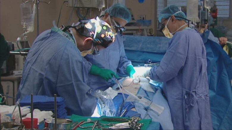 Surgeons performing a surgery.