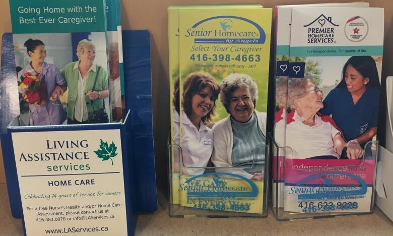 A display of three different brochures advertising companies that provide home care services.